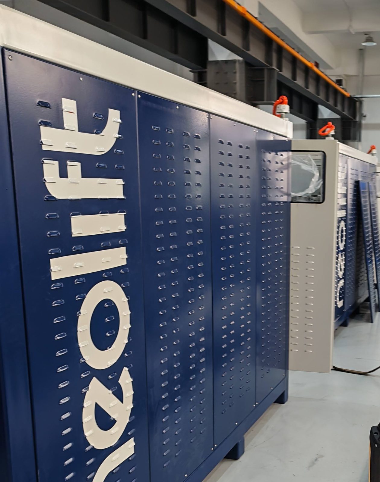 Neolift hydraulic pumping unit at the factory, perforated side panel with the Neolift mark